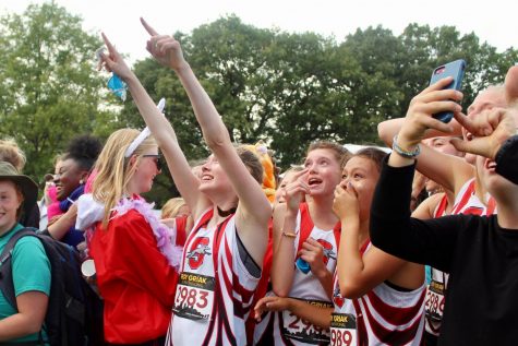 The girls country team looks at the scoreboard as it displays their first place score.