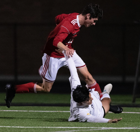 Alek Kovalcik fights for the ball against a Greenfield player. Boys soccer has had much success with a young team this season.
