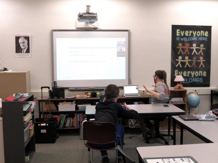 Mary DeMerit, special education teacher,
works with Theo Berges, junior, on his
schoolwork.