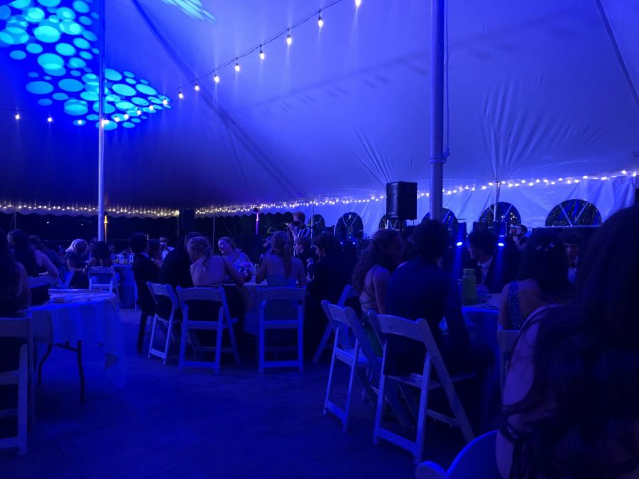 Students sit under the prom tent. The event was disappointing for many students.
